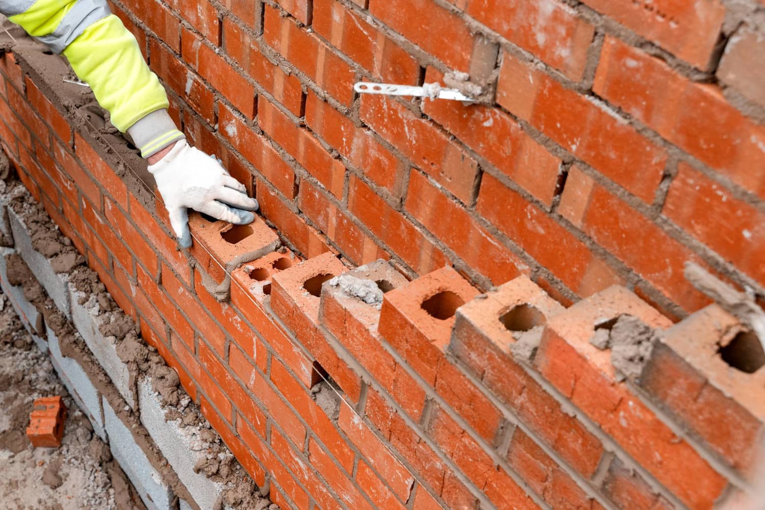 bricklayer-laying-bricks-mortar-new-residential-house-construction